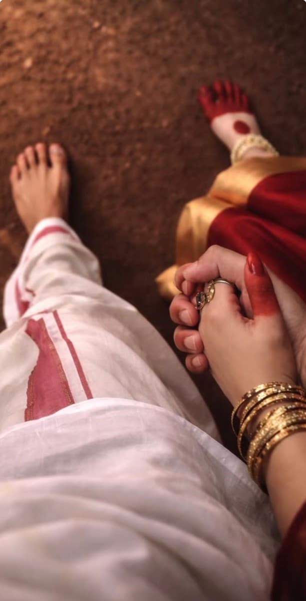 Overhead view of a couple's clasped hands during the saptapadi